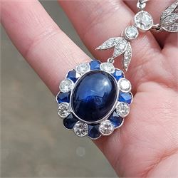 18ct white gold sapphire and diamond milgrain set necklace, oval cabochon cut sapphire surrounded by eight round brilliant cut diamonds and eight French cut sapphires, suspending from a diamond set leaf pendant, single round brilliant cut diamond and a larger old cut diamond, the chain set with six graduating cabochon cut sapphires, each surrounded by diamonds and spaced by a single diamond and a diamond set leaf, to a belcher link chain necklace, hallmarked, total sapphire weight approx 27.00 carat, total diamond weight approx 7.50 carat