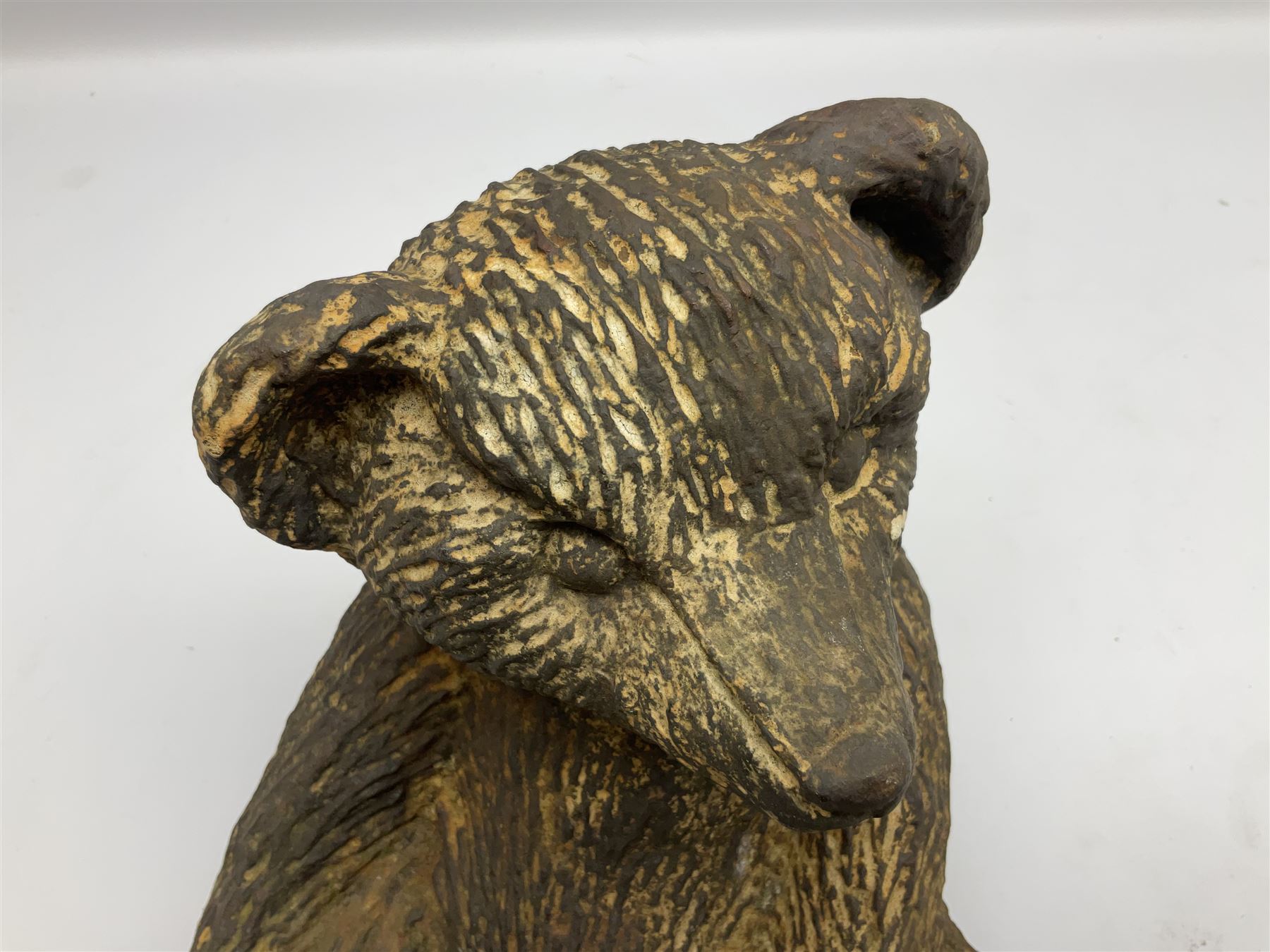 19th century cast iron door stop, modelled as a seated toy bear, with remnants of painted finish, H22.5cm