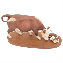Three Beswick Connoisseur Cattle: Hereford Cow and Calf, Charolais Cow and Calf and Charolais Bull, all on wooden plinths, H20cm