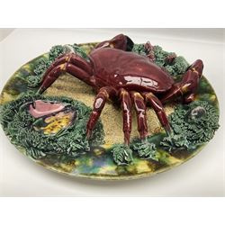 Two 20th Century Portuguese Palissy style Majolica wall plates, one depicting a crab, the other a lobster each to the centre modelled in relief surrounded by encrustations and shells, both with impress marks beneath, D34cm