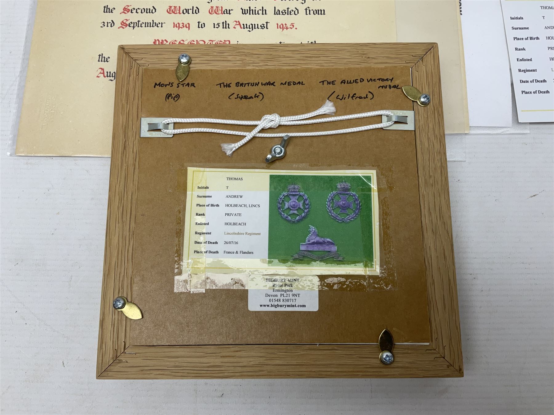 WWI group of three medals with bronze memorial plaque comprising 1914-15 Star, British War Medal and Victory Medal awarded to 16554 Pte. T. Andrew Linc. R. who died on 26th July 1916 whilst travelling to Vimy Ridge, polished and mounted for display in a frame; together with small archive of research material and two WWII V.E. Day Presentation Certificates from the people of Holbeach in Lincolnshire