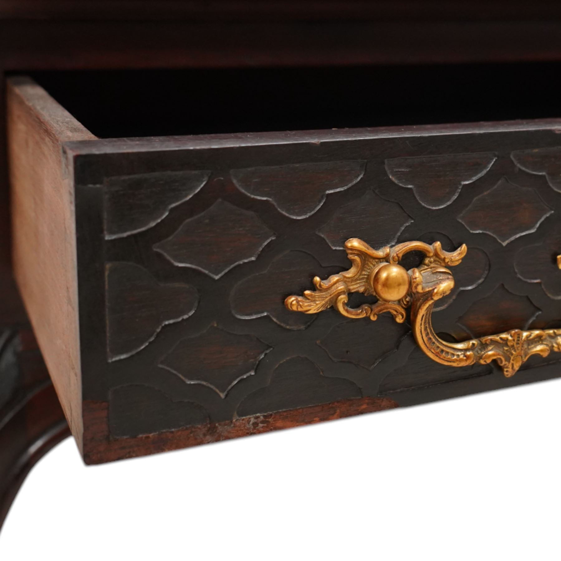 Late Victorian mahogany washstand, rectangular pale granite top over two drawers, the drawer front decorated with blind fretwork and ornate gilt cast metal handles, shaped apron carved with curled foliage, on acanthus carved cabriole supports 