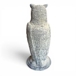 Pair of large composite stone garden statues modelled as standing horned owls, raised on circular bases