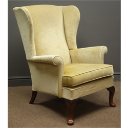  Parker Knoll beech framed wingback armchair, upholstered in beige fabric   
