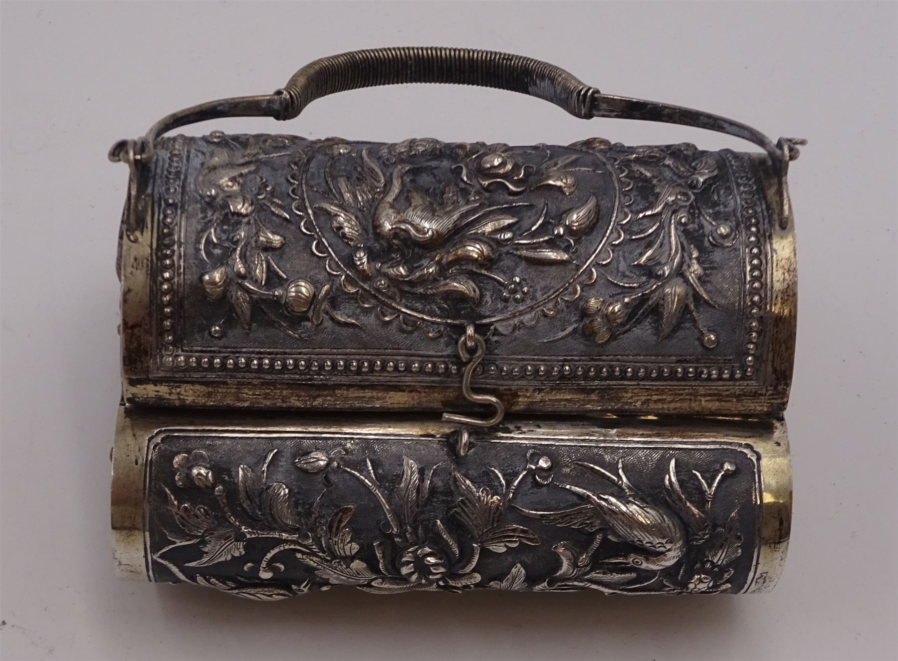 Continental silver bowl, of circular lobed form, repousse decorated with tribal and hunting scenes, upon three claw feet, unmarked but testing as 800 silver, H5cm, together with Chinese silver purse, of domed rectangular form, with ornate repousse decoration, depicting flowers, instruments, birds etc, with lobed wire wrapped handle, with Chinese character marks beneath, testing 650 silver,  including handle H11cm, and two base metal miniature animals