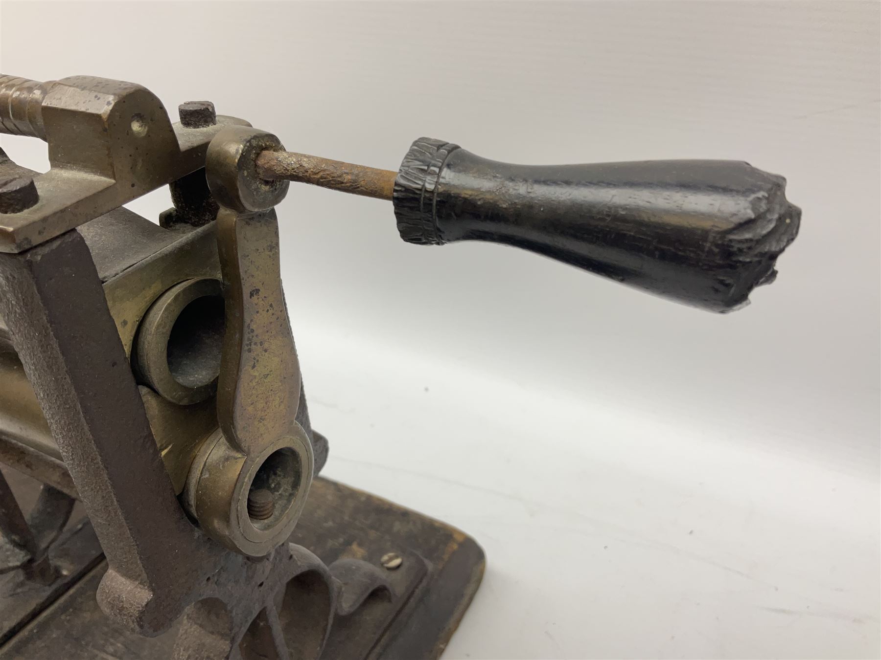Victorian cuff and collar tabletop mangle, the ribbed brass rollers in a cast iron frame mounted on a wooden base