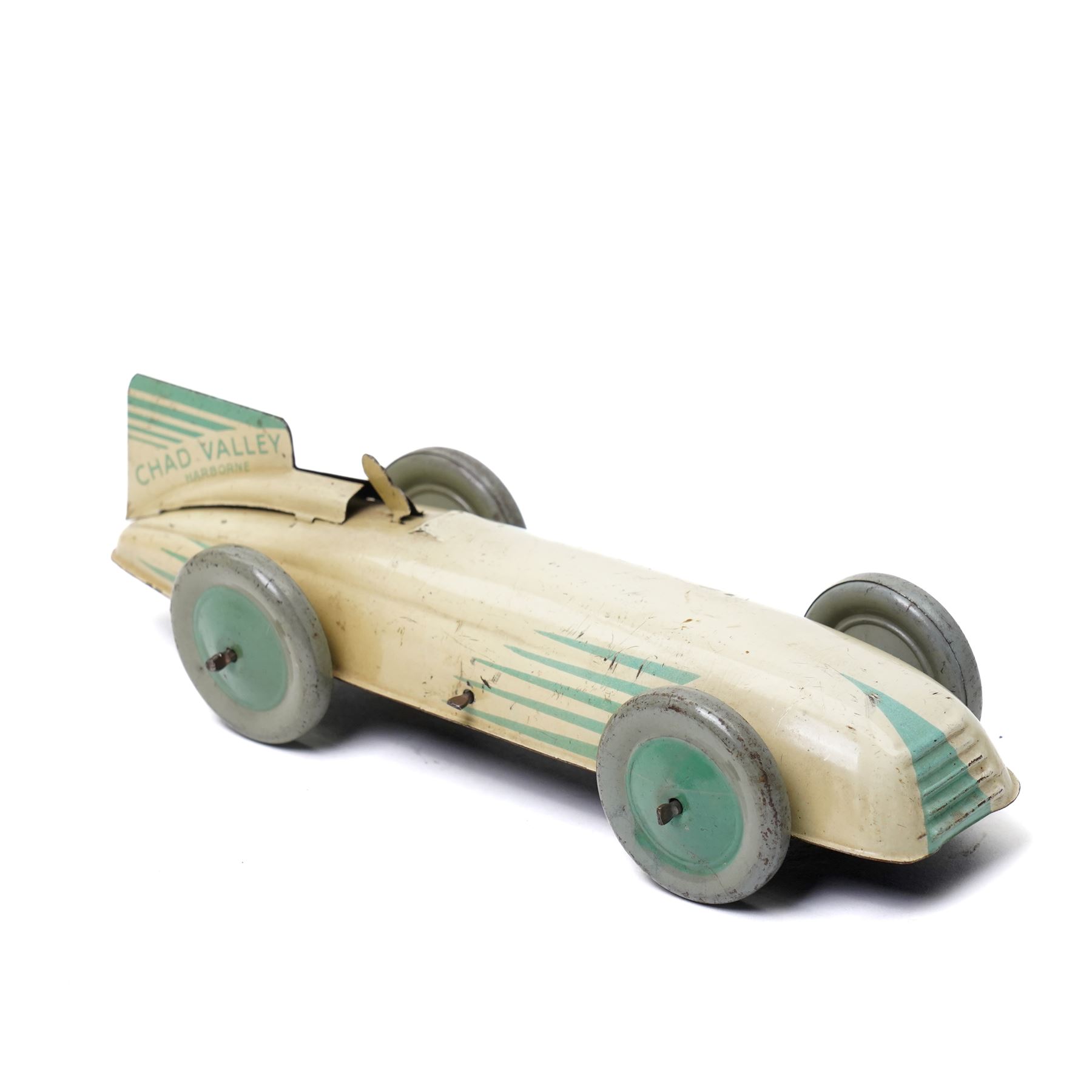 Chad Valley Harborne tin plate and clockwork racing car, cream and green with matching green hubs, length 20cm