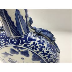 19th century Chinese blue and white moon flask vase, the central panel depicting musicians, bordered by floral, foliate and scroll decoration, with lizard handles to each shoulder, upon an oval foot, H31cm 