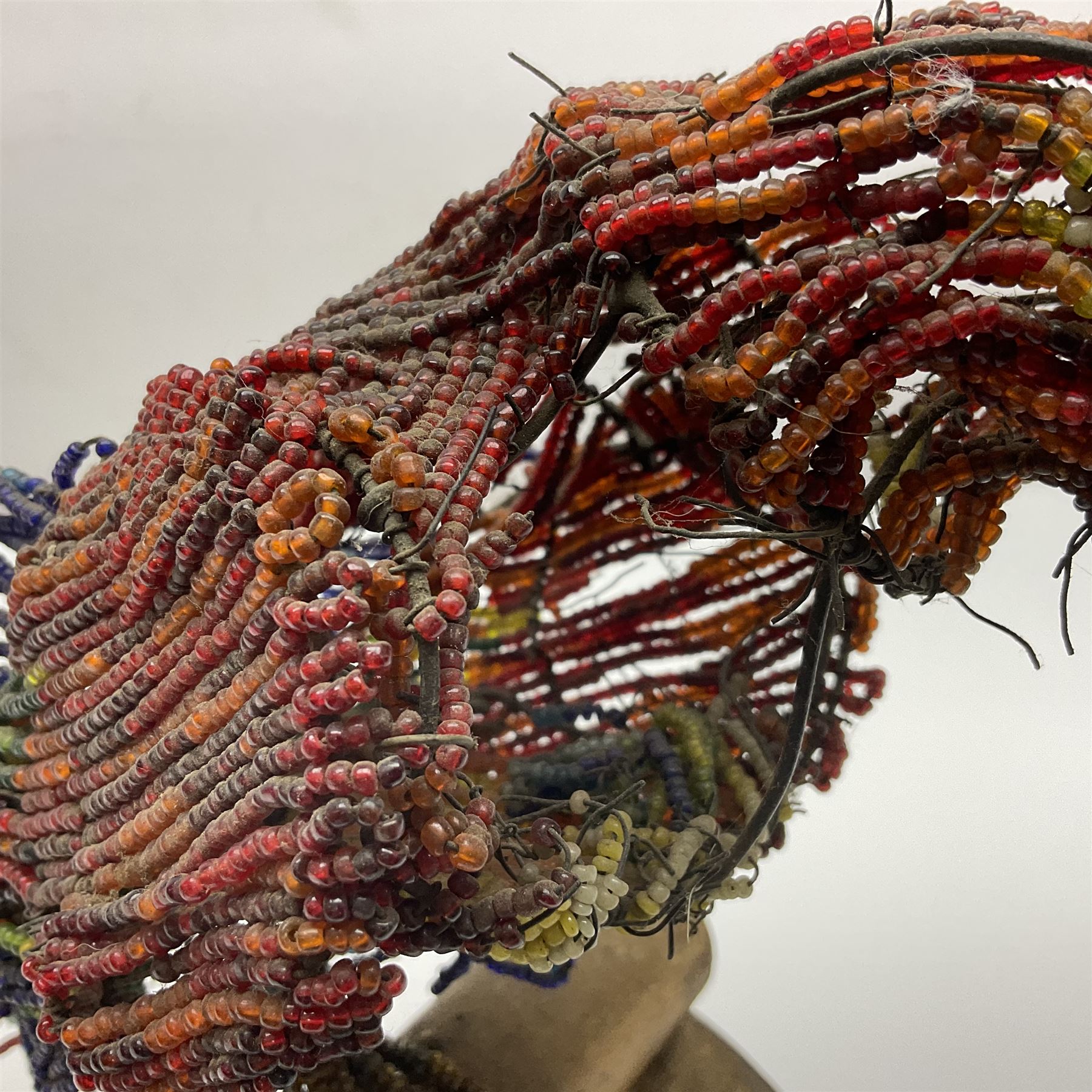 Victorian bead and wire model of a parrot, of polychrome beads, with glass eyes, on a wooden base, H24cm