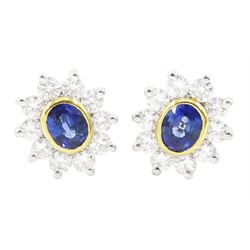 Pair of 18ct white and yellow gold oval cut sapphire and round brilliant cut diamond clust...