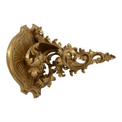 Two 20th century gilt wall brackets, comprising Rococo style carved wooden wall bracket upon a scrolling foliate support and a cast plaster bracket upon Griffin support, largest H38cm