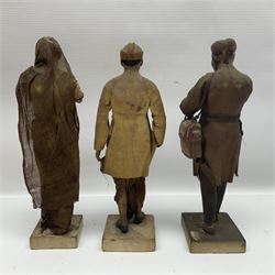 Seven 19th Century Indian clay dolls, possibly Krishnanagar, each figure with painted details, wearing cloth garments, standing on rectangular bases, some with paper label to the base, H25cm