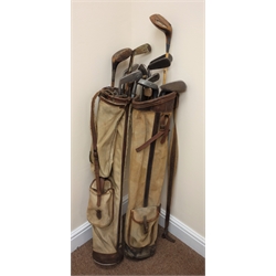  Two vintage golf bags containing various vintage clubs  