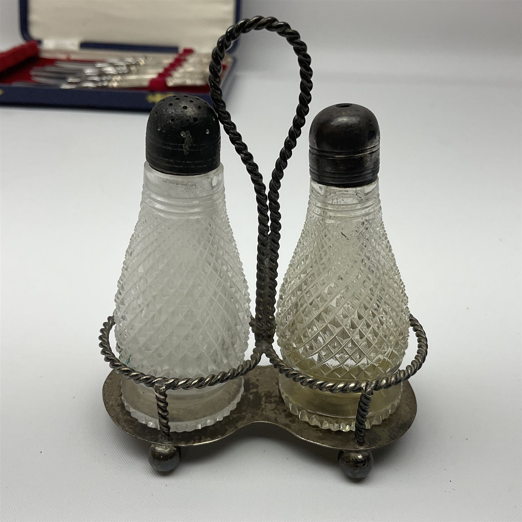 Victorian silver cut glass cruet set on stand, with diamond cut bodies, a set of six silver handled cake forks, cased, a Georgian silver mustard spoon and a silver plated shovel spoon, all hallmarked 