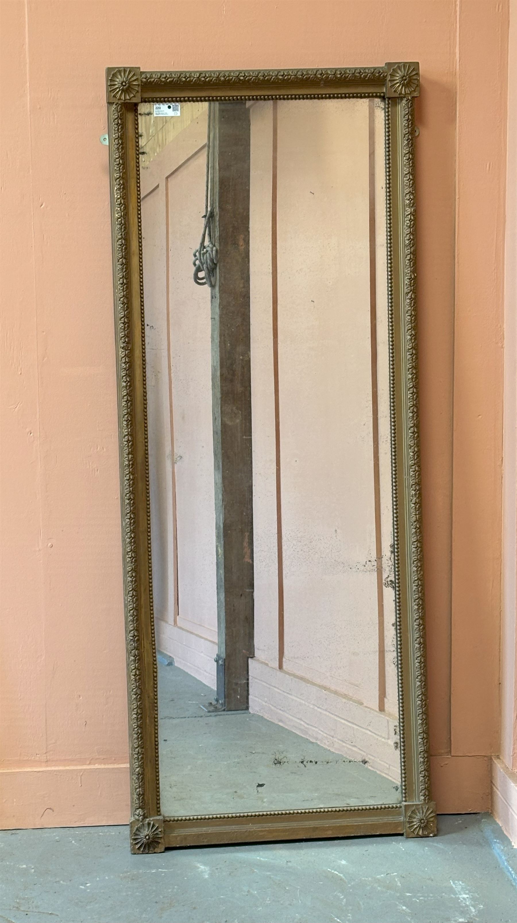 Edwardian giltwood and composition framed upright wall mirror, having a floral boss to each corner united by flowerhead decoration, enclosing an original distressed mirror plate. 193cm x 77cm.  - COLLECTION BY APPOINTMENT FROM: The White House, Thirsk Road, Easingwold, York, YO61 3NF - CALL 01723 507111 TO ARRANGE