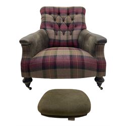 John Sankey - low armchair, buttoned back upholstered in tartan patterned fabric with contrasting grey leather, raised on turned and ebonised front feet with brass and ceramic castors, with matching foot stool