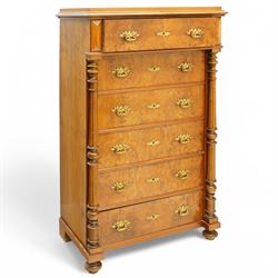 Tall late 19th century walnut chest, stepped and moulded top over six drawers, ornate cast gilt metal handles, enclosed by turned and fluted upright columns, on turned front feet 