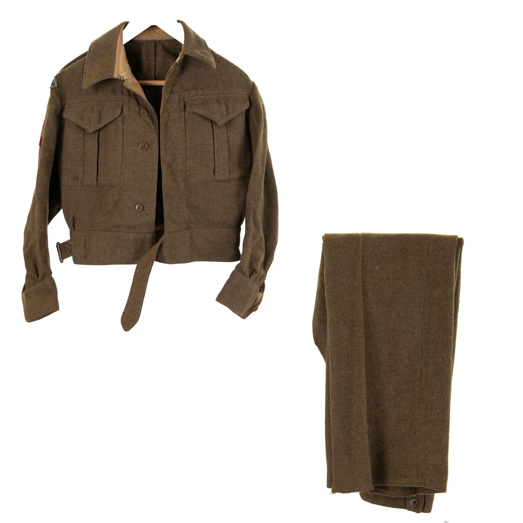 WWII British parachute regiment battle dress uniform, the jacket with shoulder title and Pegasus formation badge to the left arm, shoulder title, Pegasus formation badge and cloth wings to the right, size 3 dated 1943, the trousers size 3 dated 1945 