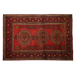 North East Persian Kurdish hand-knotted carpet, madder red field with three vertical and c...