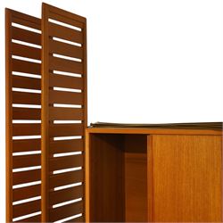 Ladderax - mid 20th century teak modular wall unit, comprising two sliding door cabinets, one fall-front cabinet, six shelves, four ladder supports and fourteen metal cross braces