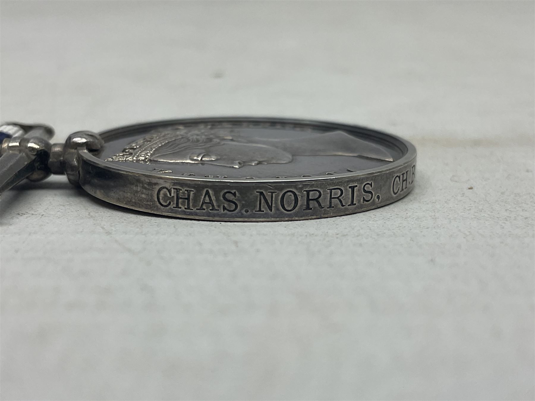 Victoria Naval Long Service and Good Conduct Medal with narrow suspender, awarded to Chas. Norris, Ch. Boatn. H.M. Coast Guard.; with ribbon