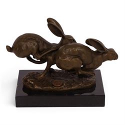 Bronze figure group, modelled two hares in chase, upon naturalistically modelled oval base signed Nick and with foundry mark, raised upon black marble base, H11cm L12.5cm