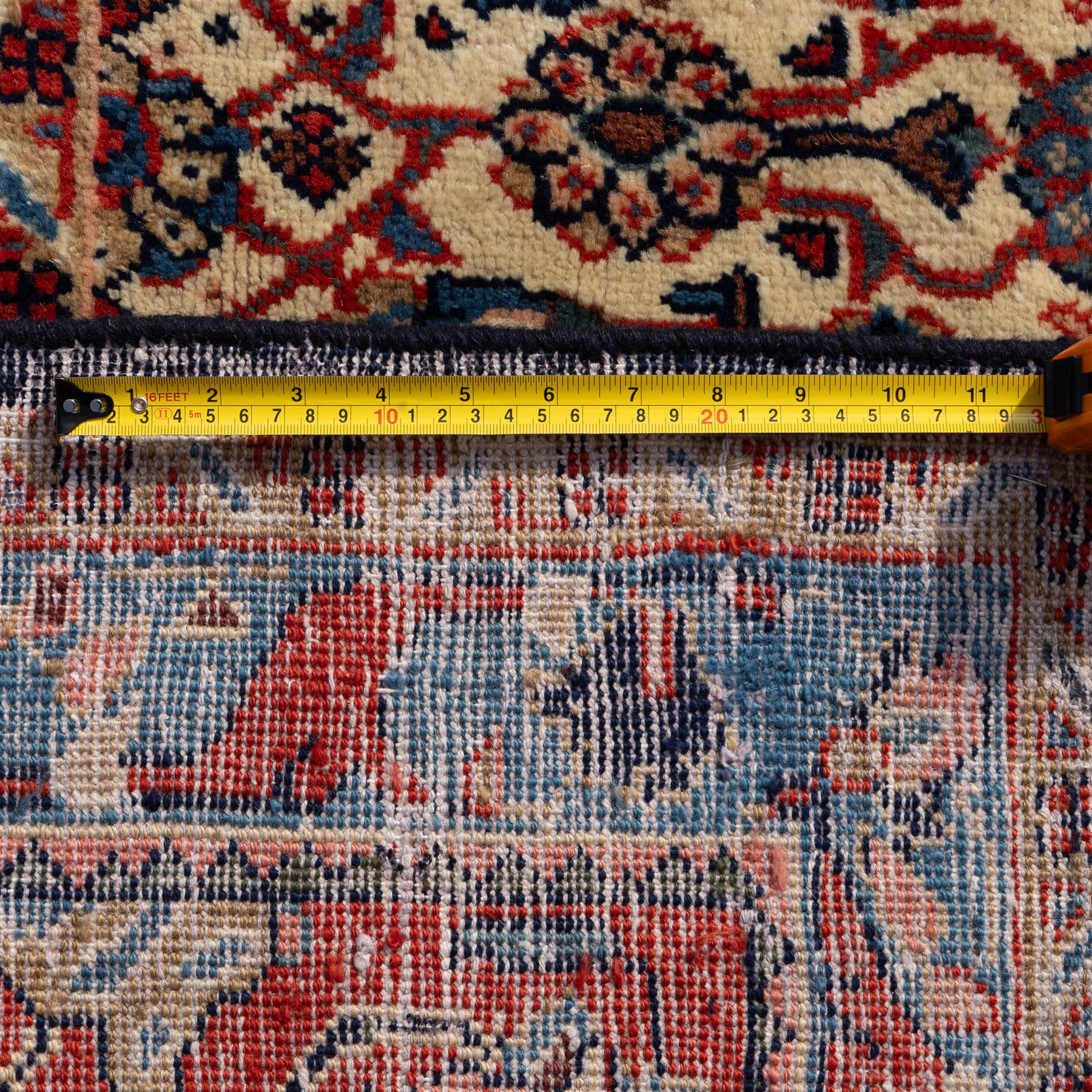 Large West Persian Bidjar hand-knotted carpet, deep indigo field with central medallion with pendants issuing an all-over design of scrolling vines, palmettes, and floral sprays, within conforming spandrels, enclosed a broad madder red palmette, and vine border framed by guard stripes, in a palette, of indigo, madder red and ivory tones, with cotton fringe ends 