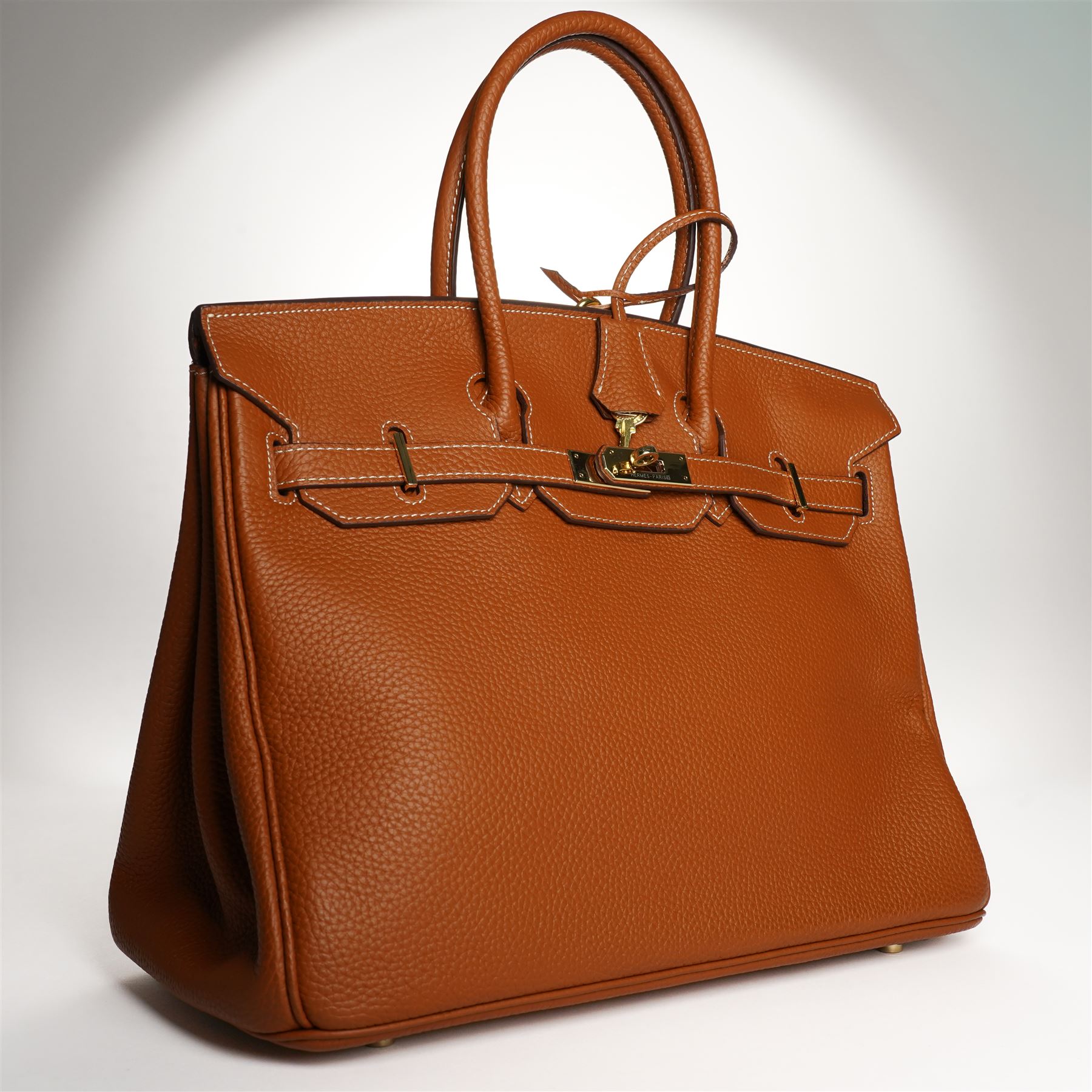 Hermès - gold hardware 'Birkin 35' handbag in gold Togo leather with white stitching, featuring gold-plated hardware, double rolled handles, front flap, belted turn-lock closure, and leather lining with one zip and one slip pocket, stamped 'Hermes Paris Made in France' in gold, with blind-stamp Q (2013) with craftsman’s code 70A to the underside of locking belt. Accompanied by: padlock, keys, clochette, Hermes dust bag, booklet, and ribbon. New unused condition.