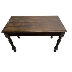 Late 19th century oak side table, rectangular top with shaped edge over faux panelled frieze, raised on arcade carved and ring turned supports 