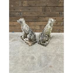 Pair of cast stone garden dogs and 2 female figures,