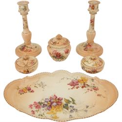 Royal Worcester blush ivory dressing table set, decorated with flowers, comprising an oval tray, three covered pots and a pair of candlesticks 