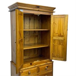 Solid stained pine double wardrobe, fitted with two panelled doors above two short and two long drawers