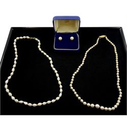 Pair of 9ct white gold white/cream pearl stud earrings, in Mappin & Webb box, single strand graduating white/pink pearl necklace with gold clasp stamped 9ct and one other pearl necklace