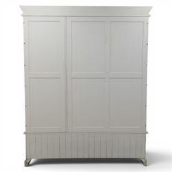 Modern white three door wardrobe, with two hanging section and shelving area, above a long drawer and a short drawer to the base, raised on a moulded plinth