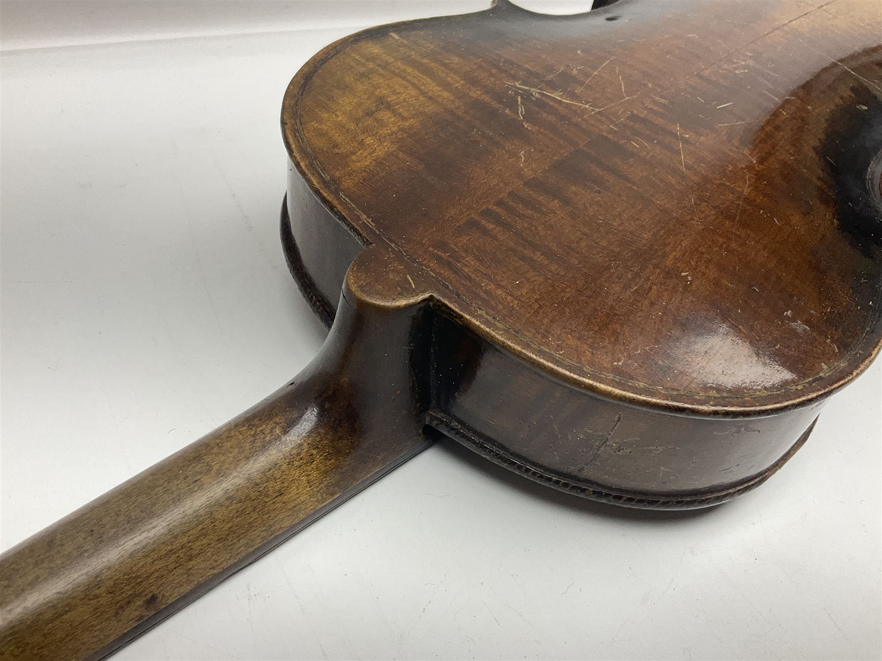 German violin c1890 with 36cm two-piece maple back and ribs and spruce top; bears label 'Antonius Stradivarius Cremona Faciebat Anno 1729' L59.5cm overall; in ebonised wooden 'coffin' case; and two German violins c1890 for completion - one bearing a Stradivarius label, the other a Ruggeri label; both in carrying cases (3)