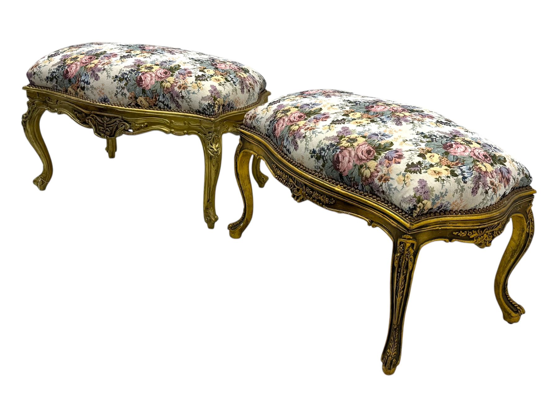 Pair of Louis XV-design giltwood stools, each upholstered in floral tapestry fabric, the carved frame adorned with scrolling foliage and shell motifs, raised on cabriole supports