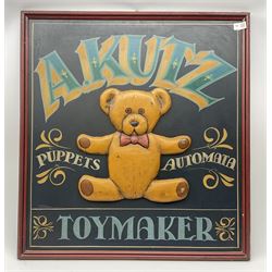 A Kutz Toymaker sign with central low relief decoration of a teddy bear, H76cm L71cm.