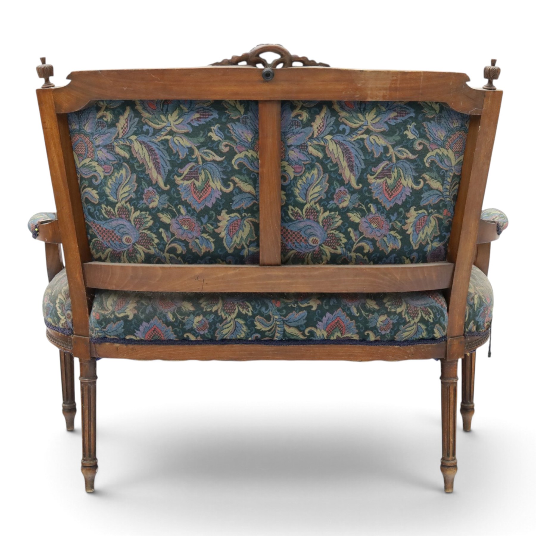 20th century French Louis XVI style stained beech two-seat salon settee, rectangular upholstered back and seat in floral tapestry fabric, carved and moulded frame with foliate cresting, padded open arms and fluted tapering supports