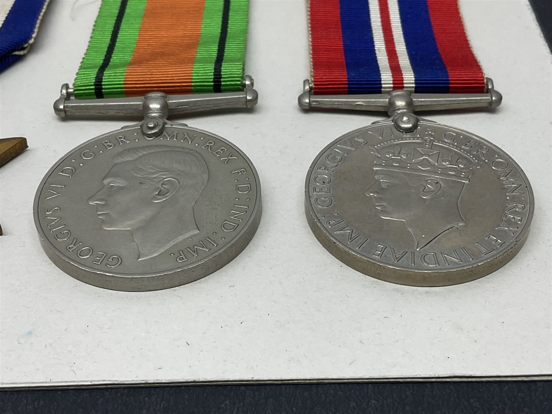 Representative display of WWII Campaign Stars and Medals comprising Burma Star, Italy Star, France & Germany Star, Defence Medal and War Medal 1939-1945; together with the corresponding group of miniatures; all with ribbons