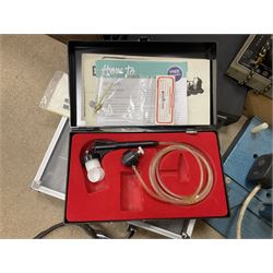 Six shelved cabinets for displaying ‘00’ gauge locomotives comprising plain plywood and white painted examples with track applied to various shelves, largest H63cm, W107cm, D27cm; Collection of tools for building model locomotives to include Weller PU-2D Soldering Pencil and Standard Tip Soldering Iron 20W/230V, Humbrol Modellers Airbrush, Power Supply Units and two wooden chests one of which housing a collection of tools including tweezers, scalping tools, wrenches etc 