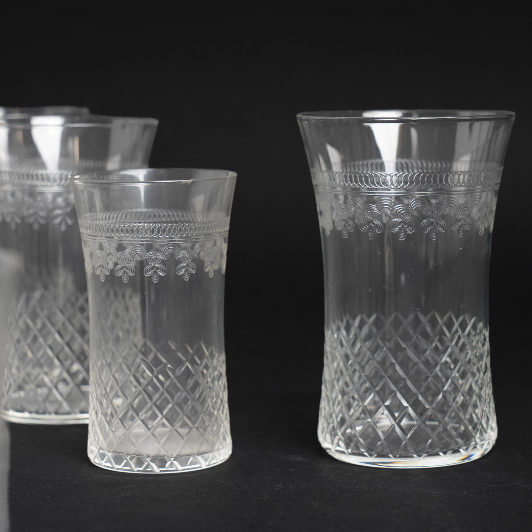 Suite of early 20th century cut and etched table glass comprising nine tumblers, ten smaller tumblers, eleven small wine glasses, six sherry glasses and water jug together with four other sherry glasses