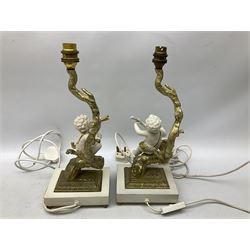 Pair of gilt and ceramic table lamps depicting putti sitting upon a tree playing a horn, together with a pair of similar table lamps, depicting putti sitting upon a tree playing a lute, H38cm