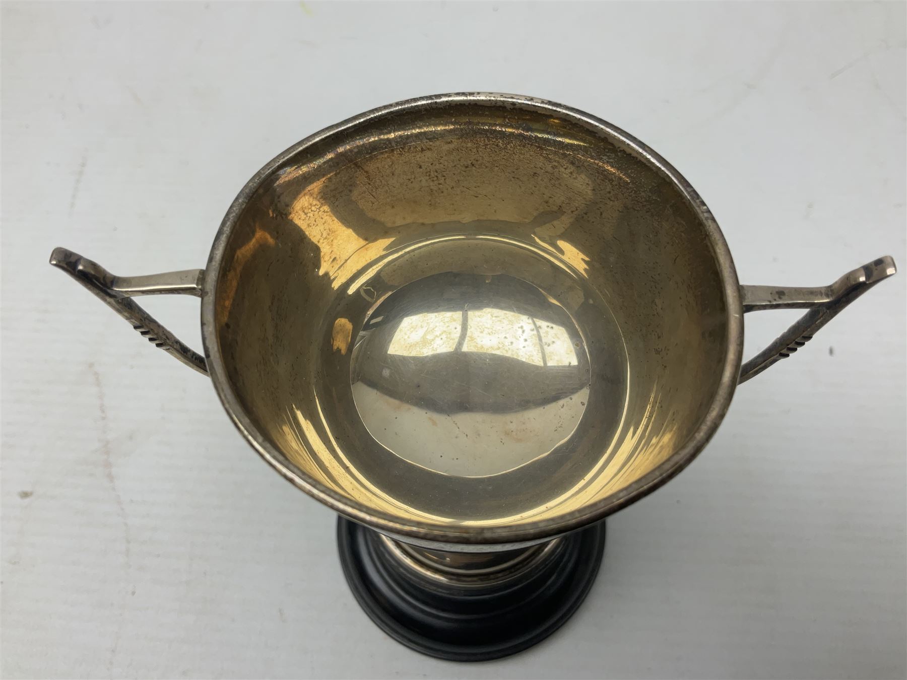 1930's silver twin handled trophy cup, upon black circular plinth, hallmarked Birmingham 1936, approximate silver weight 47 grams