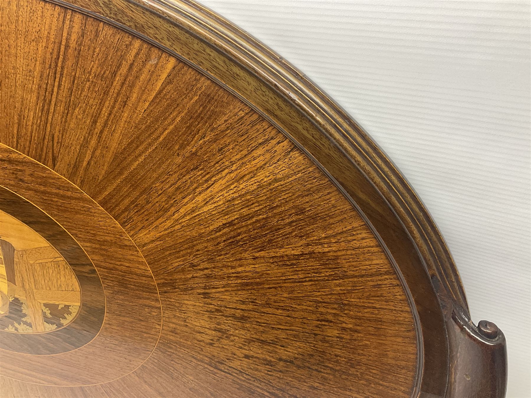 Late 19th/early 20th century mahogany and marquetry inlaid tray, of oval form with twin scrolled handles and moulded border, the central panel inlaid with figures seated at a table drinking tea, L99cm