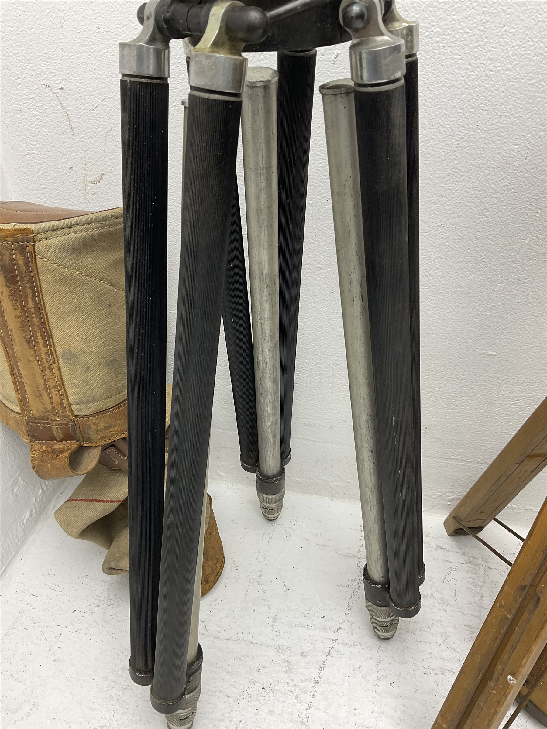 Three wooden adjustable tripods for plate cameras, together with a Linhof of Munchen metal tripod in a canvas case 