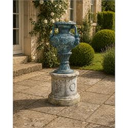 Large impressive Classical cast bronze center-piece urn, twin scroll handles with grape garlands, cherub masks and relief detail, raised on a circular cast stone pedestal with moulded detail