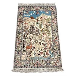 Fine Persian tree of life rug wall hanging, ivory ground field depicting landscape filled with animals, birds and flowers, the guarded border with stylised flower heads and foliage decoration, with brass hanging rail