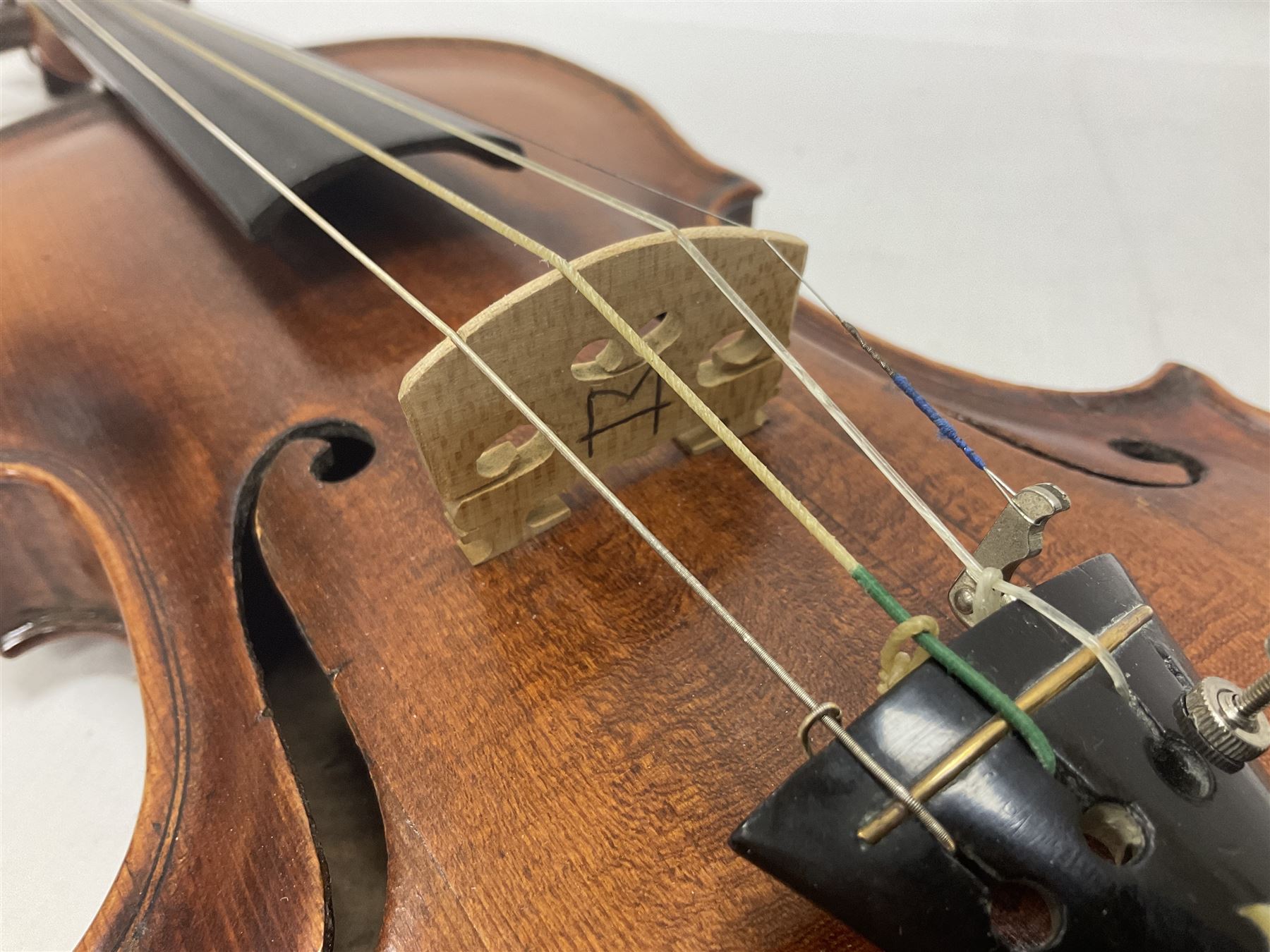 19th century full sized violin in a later hard case, decorative mother of pearl inlay to the tail piece Overall length 60cm No bow
