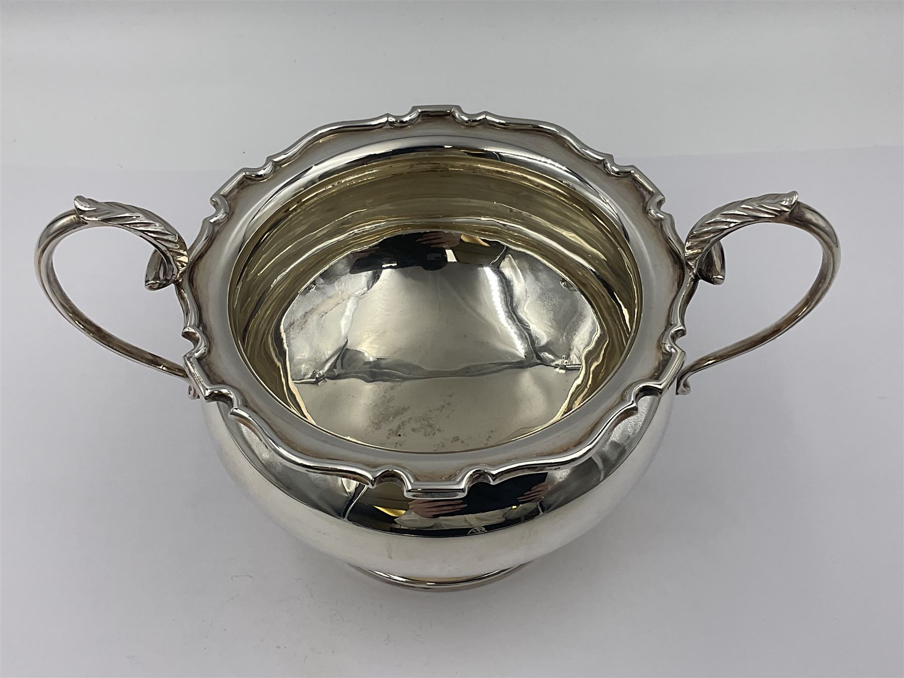 1920s five-piece silver tea service, comprising teapot, coffee pot, hot water pot, twin handled open sucrier and milk jug, each of squat circular form with shaped rim, the teapot, coffee pot and hot water pot each with ebonised handle and finial, the sucrier and milk jug with acanthus capped scroll handles, all upon circular foot, hallmarked R F Mosley & Co, Sheffield 1926 & 1927, tallest H24cm