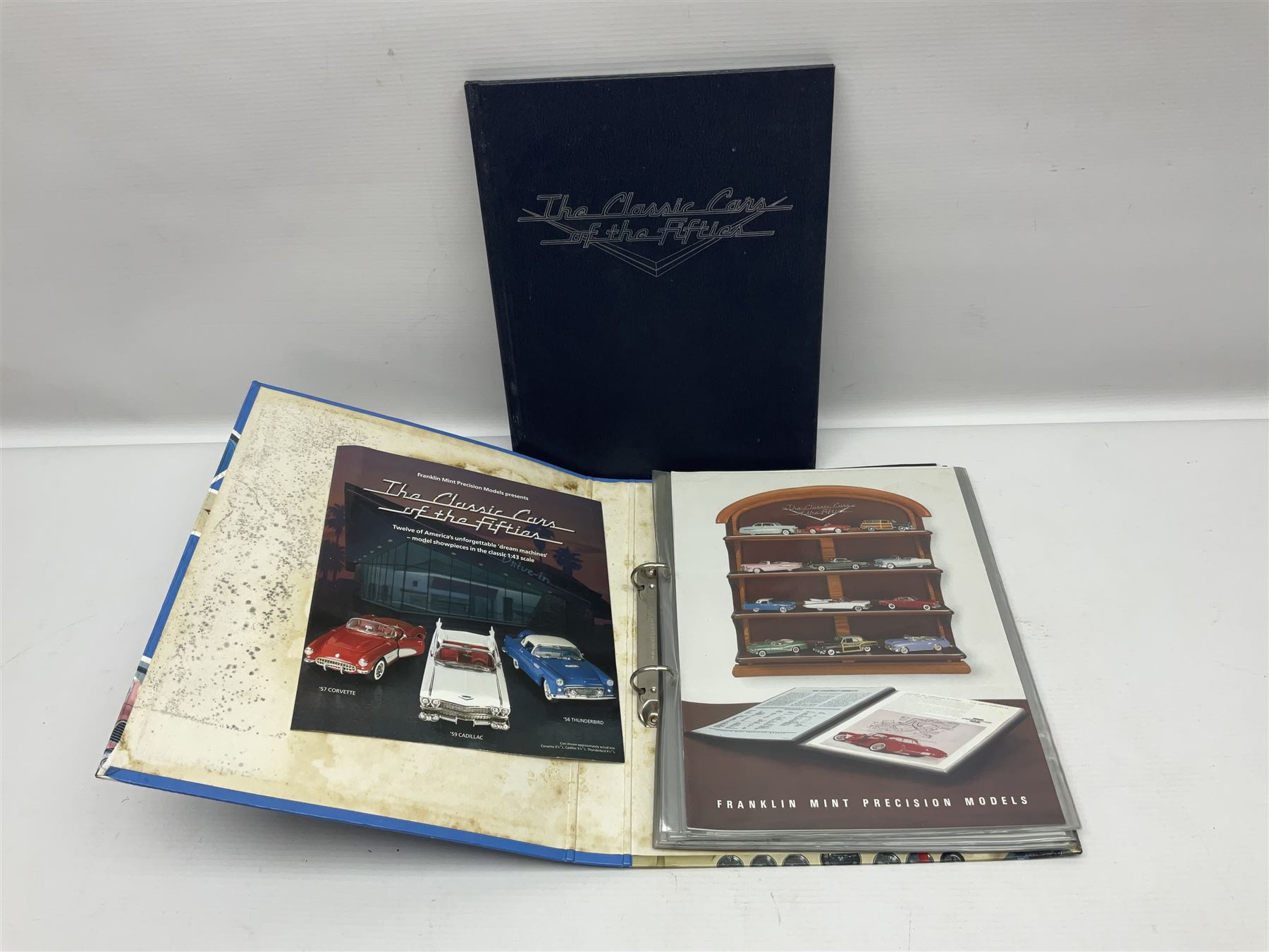 Franklin Mint 'The Classic Cars of the Fifties' collection with display rack, eleven (ex.12) die-cast models and folder of paperwork; another wall mounting display cabinet containing fifteen die-cast models; and an unused boxed Master Tools model display case
